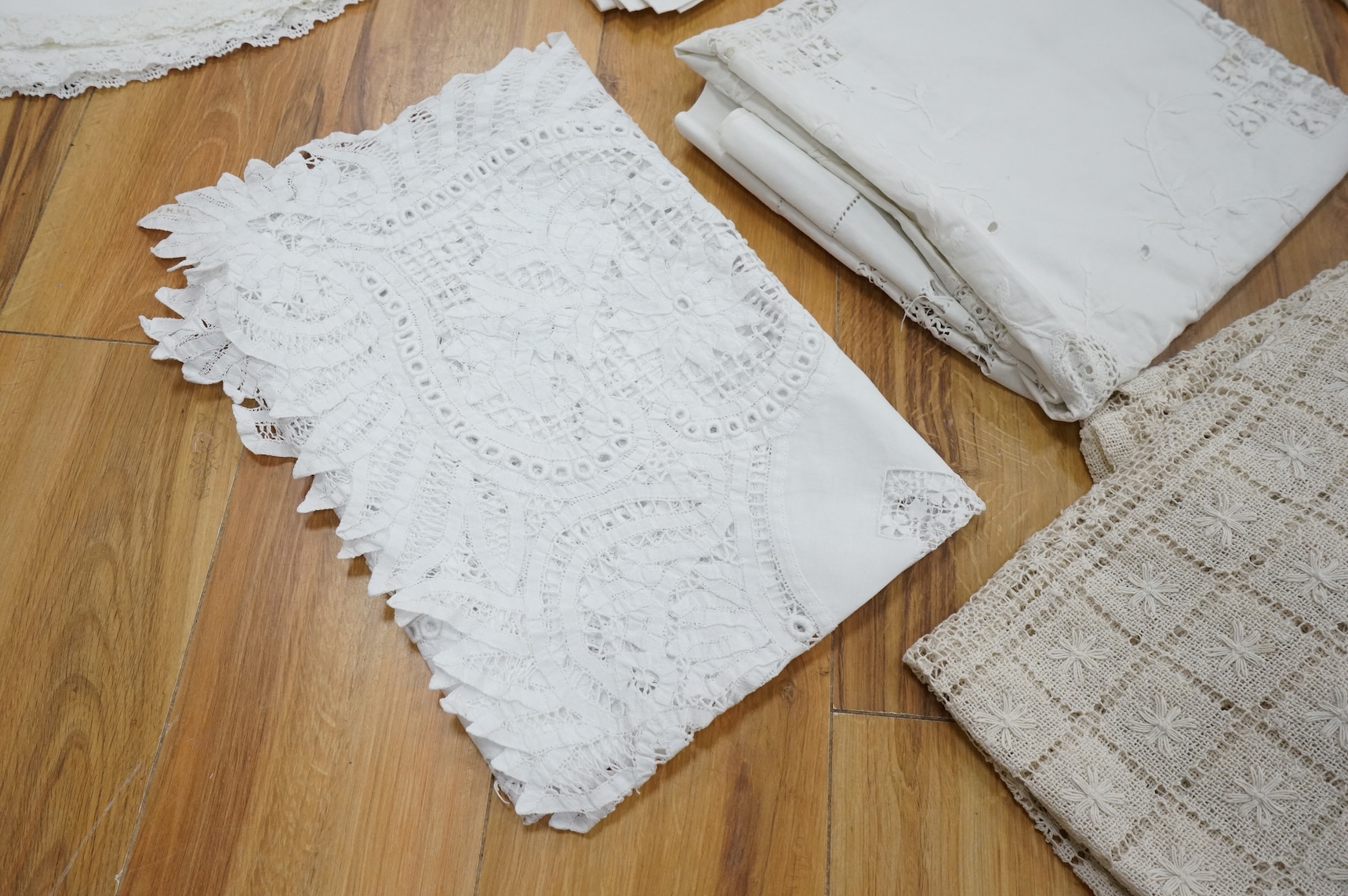 A collection of early 20th century and later crochet, cut work and drawn thread table linens and a large embroidered table cloth